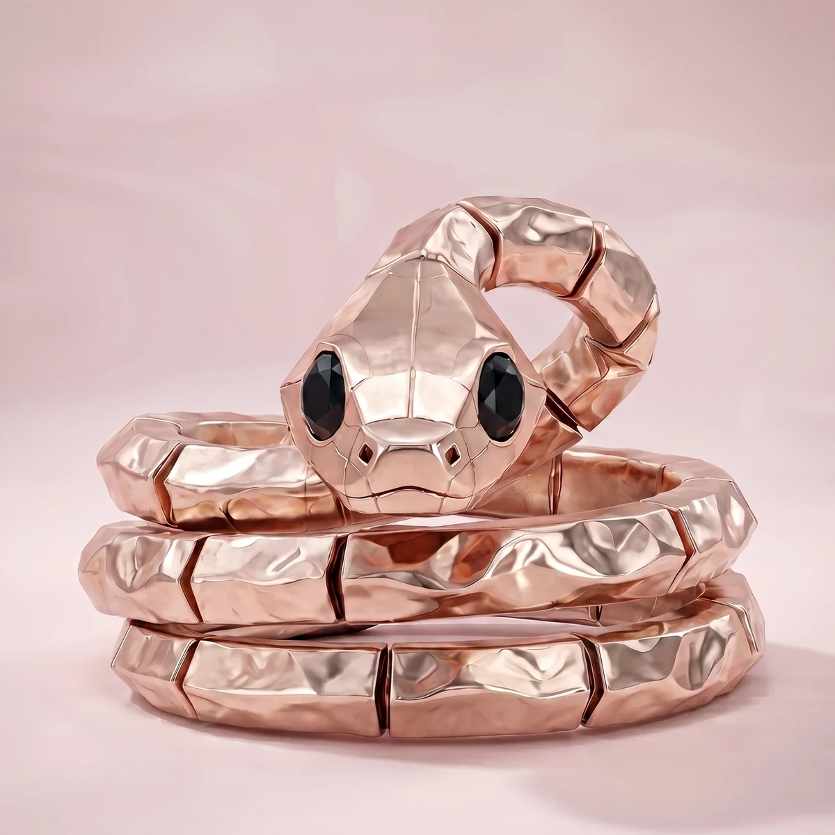 Rose gold serpent ring with black onyx eyes coiled three times