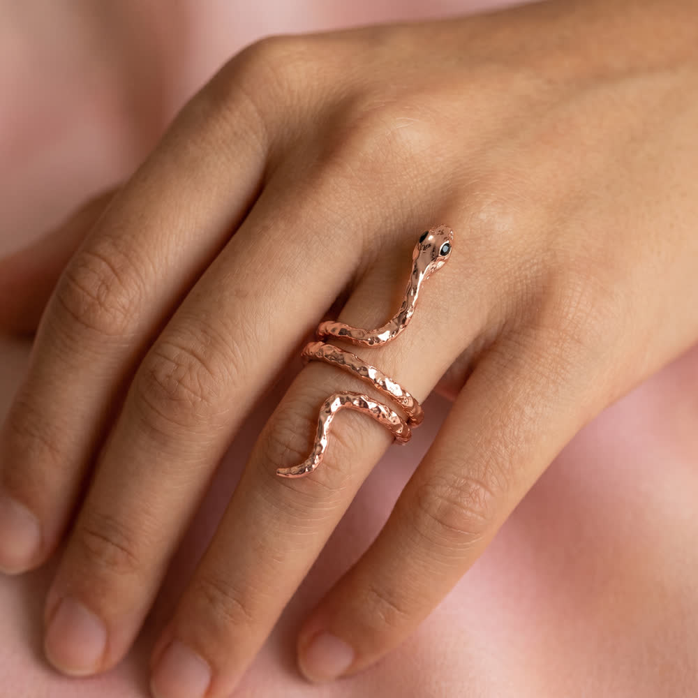 Rose gold serpent ring worn on the hand